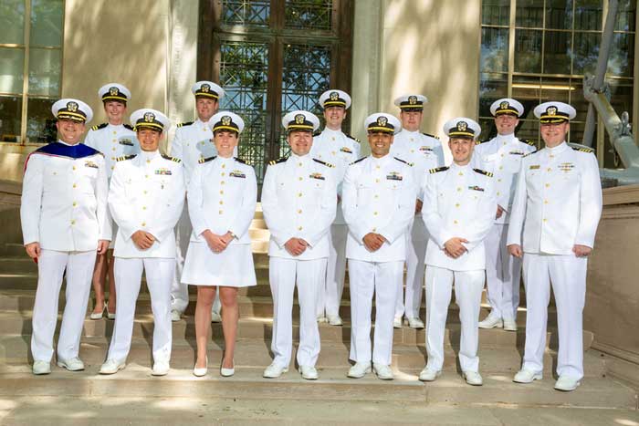 Group photo of 12 grads in Navy uniform