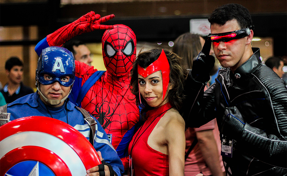 A group of people dressed in superhero costumes at a convention