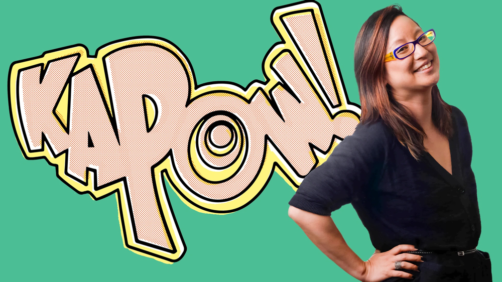 Amy Chu in front of a green background with "KaPow" written in big letters